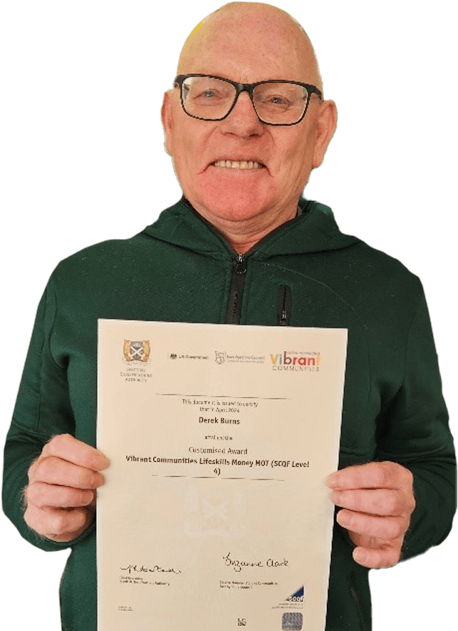 A learner with a certificate, showing that he has achieved a qualification at SCQF level 4. It's for a Money MOT course run by Vibrant Communities within East Ayrshire Council.