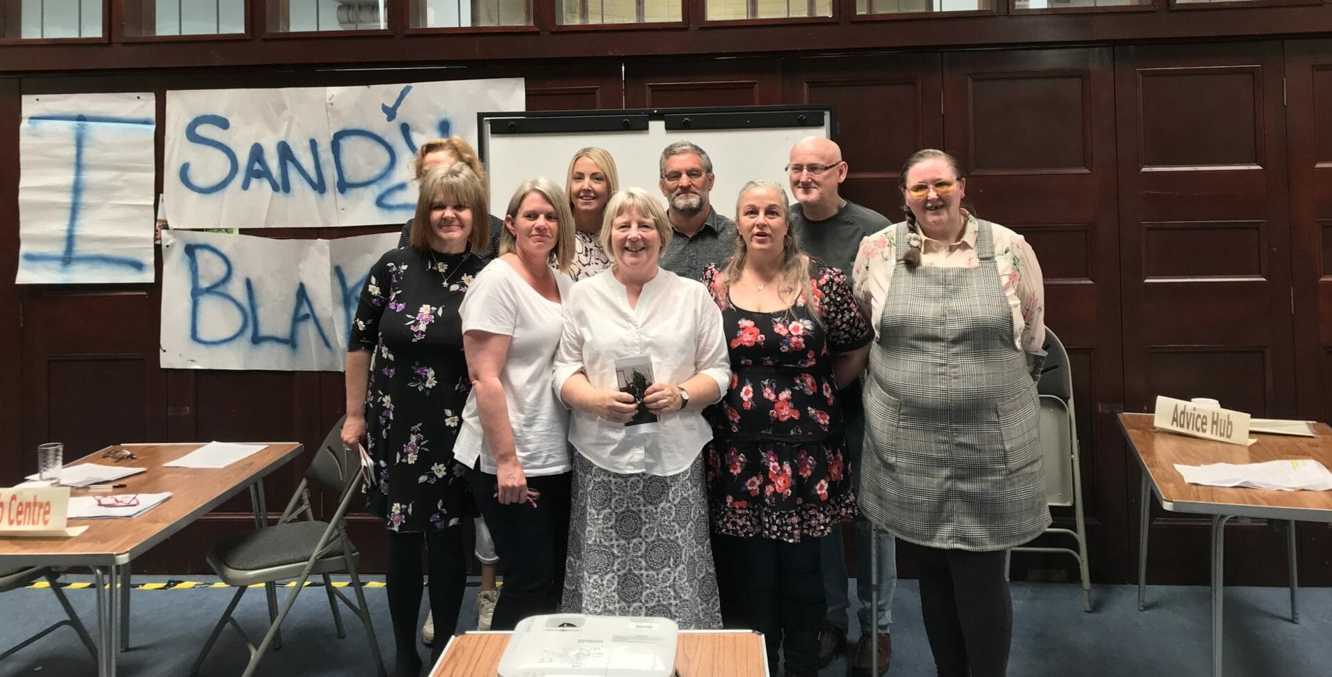 Participants from the Health Issues in the Community course, which is on the SCQF, stand together in a group, smiling at the camera.
