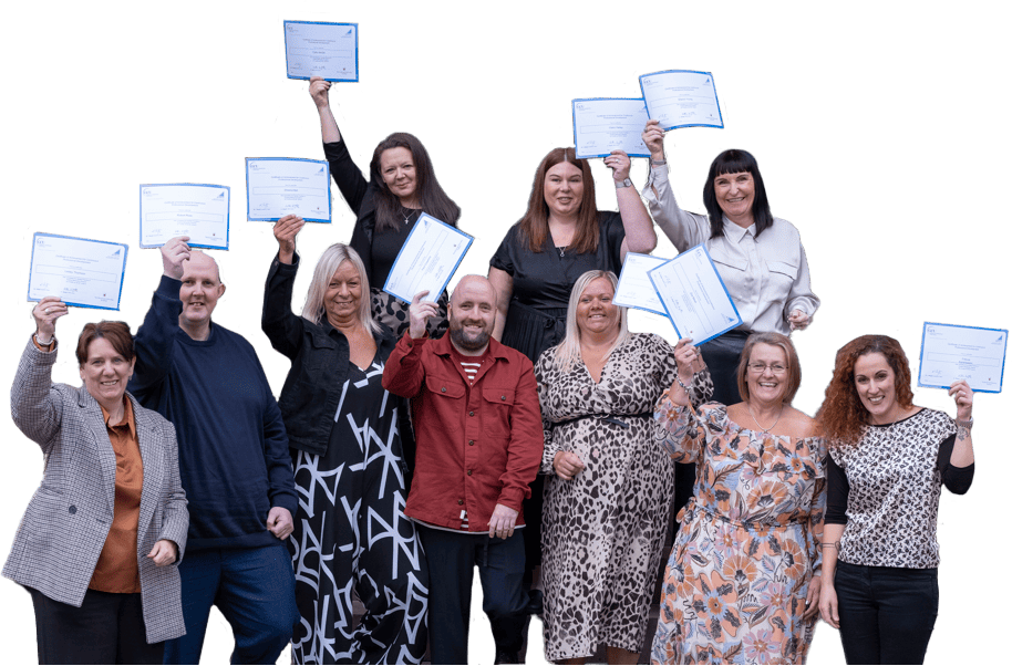 A group of adult learners who undertook a qualification that features on the SCQF while in the workplace. They are smiling, and holding up their certificates.