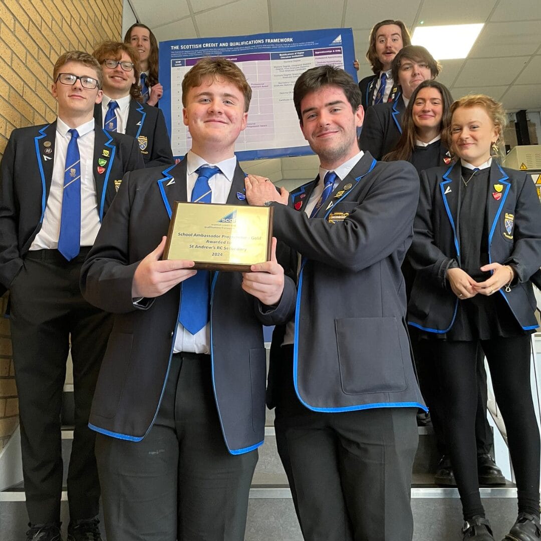 Nine SCQF Ambassadors from St Andrew's Secondary School, in Glasgow, hold up their gold SCQF Ambassador plaque