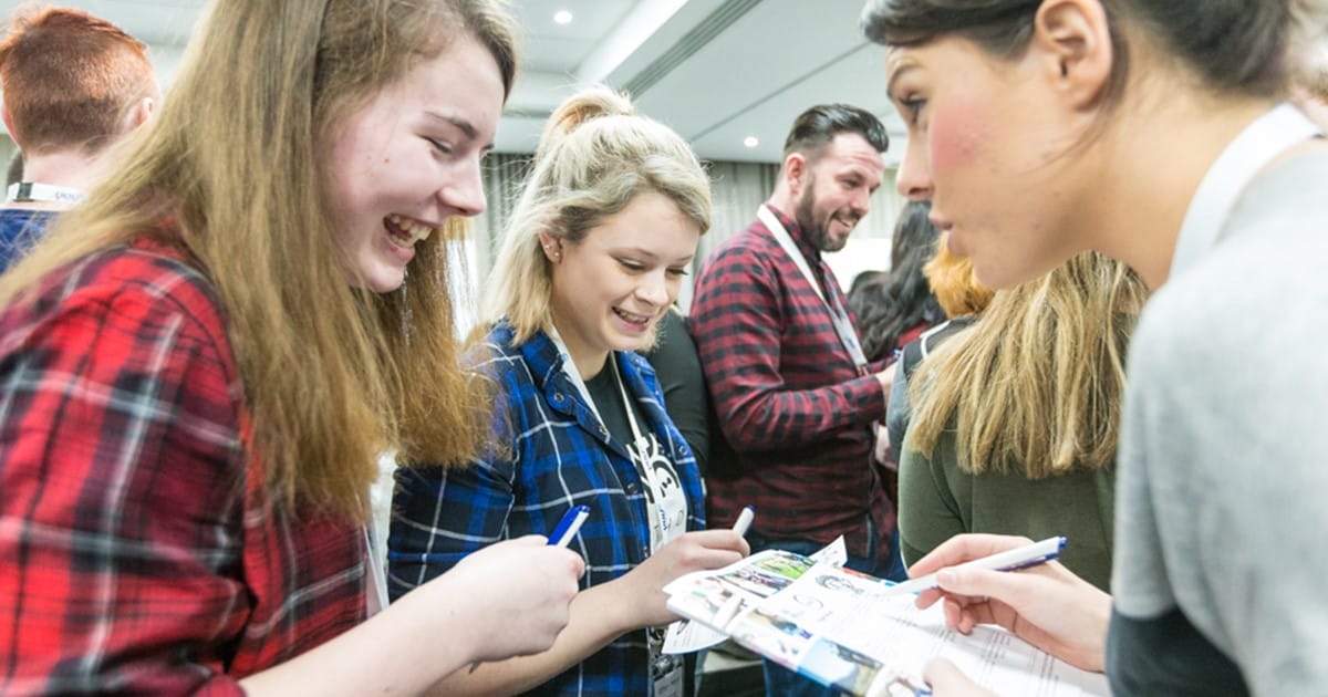 Students talking to one another at a networking event