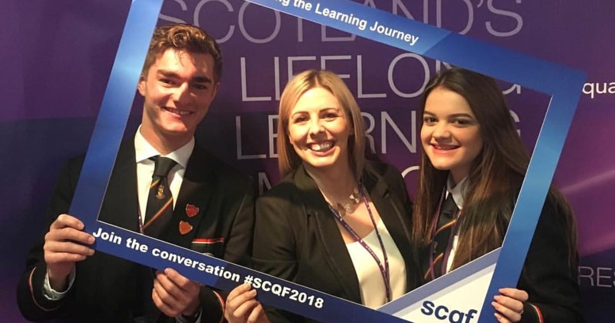 Teacher & pupils from Bearsden Academy at SCQF Conference holding a selfie frame