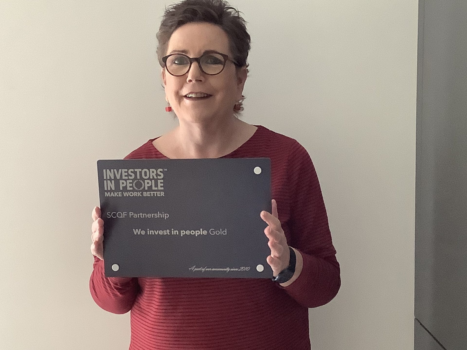 Aileen Ponton with IiP gold plaque
