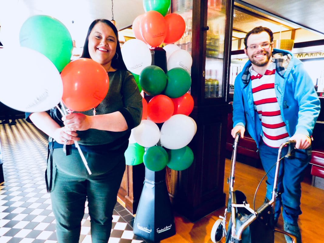 LEAD Scotland service users holding balloons and smiling at the camera
