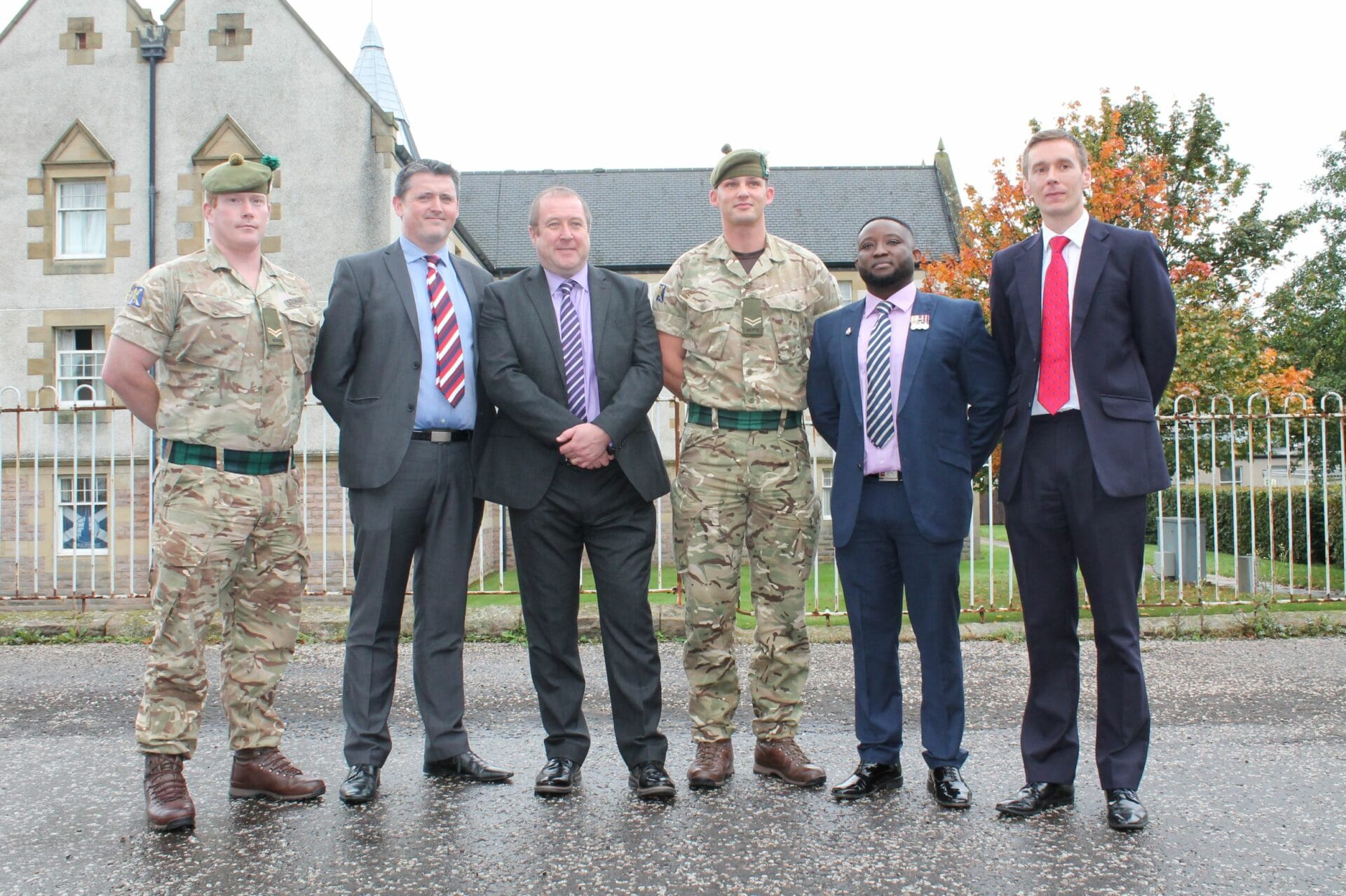 Scottish Veterans Minister, Graeme Dey, with current and former soldiers outside barracks in Edinburgh