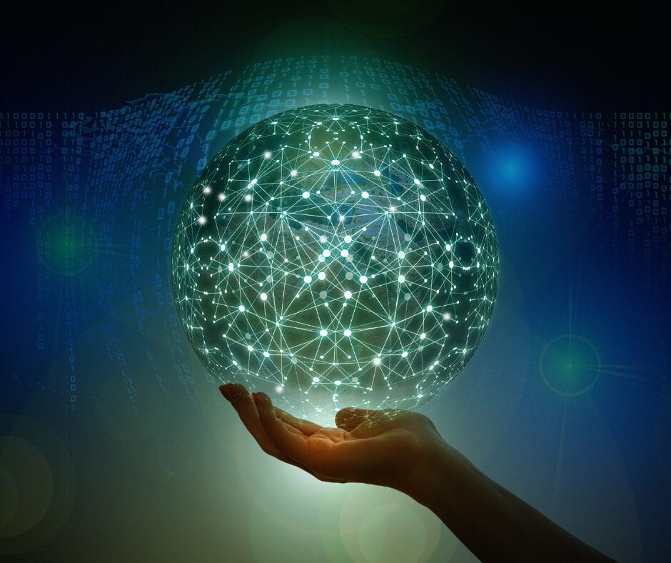 Picture of a hand holding a globe that is lit up, highlighting connections