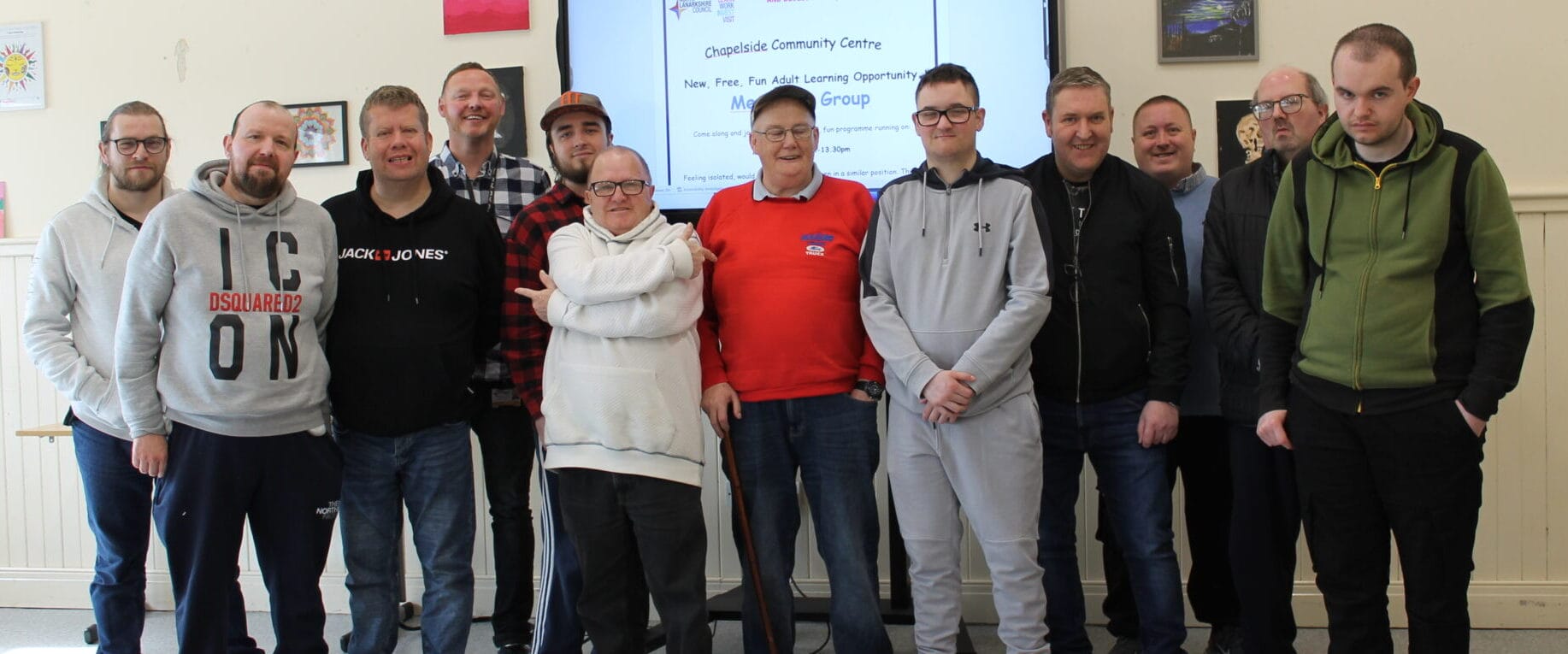 Airdrie Menspace members stand in a row